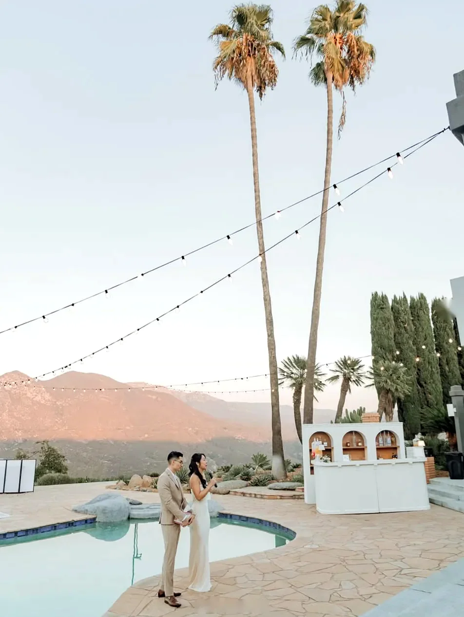 Couple giving a toast by the pool at golden hour in Valley Center